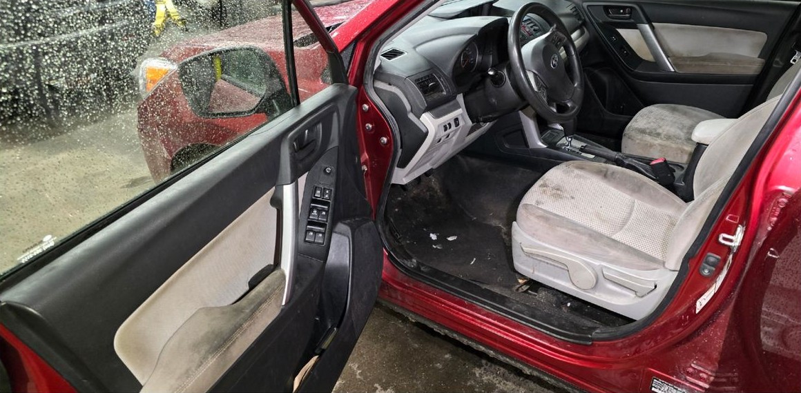 Front cabin before cleaning with stained seat, door panel and dirty floor