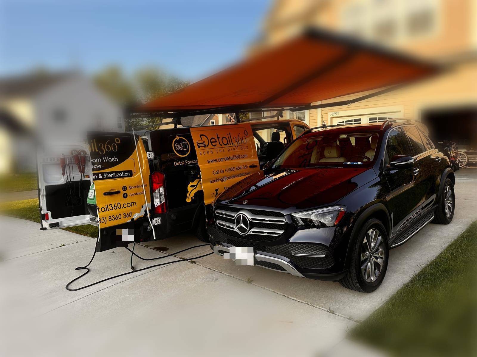 Car Detail 360 mobile van with awning set up beside a Mercedes-Benz GLE in a customer's driveway